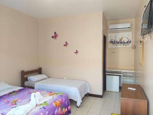Katil atau katil-katil dalam bilik di Pousada Planeta Guarajuba
