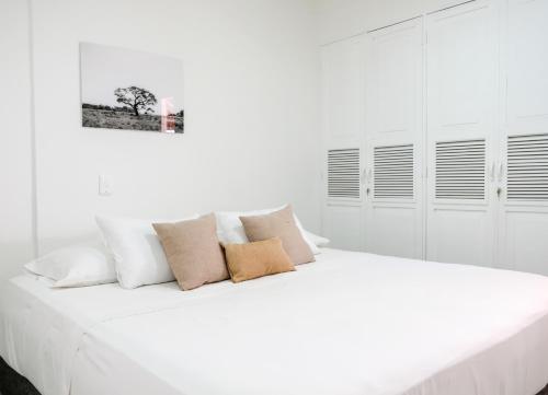 a white bedroom with a large white bed at Mucura Hotel & Spa in Cartagena de Indias