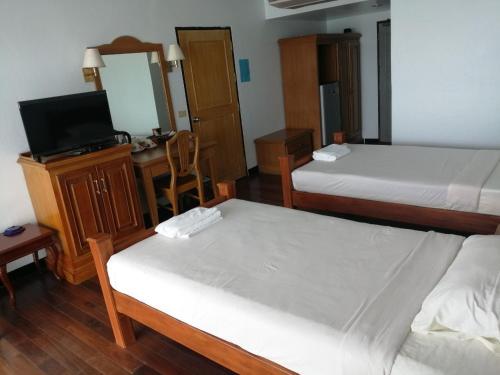 Postel nebo postele na pokoji v ubytování Jansom Beach Resort