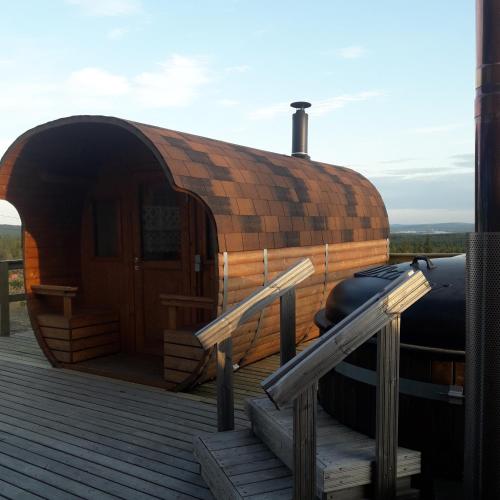 a yurt with a wooden door and some stairs at Karemajat Panorama hotel in Ylitornio