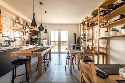 a kitchen with wooden tables and stools in it at Magnolia by Radovanovic in Petrovac na Mlavi