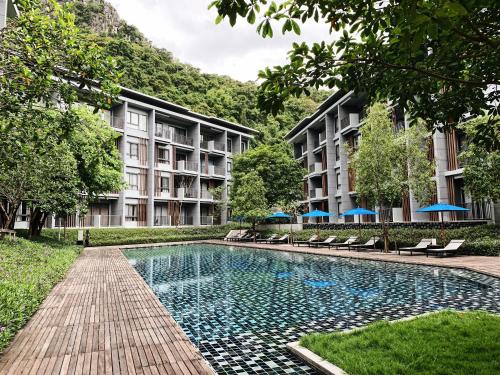 a swimming pool in front of a building at 23 Degree Khaoyai 2 Bedroom Tropical style in Ban Huai Sok Noi