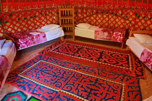 
a bed room with two beds and two lamps at Happy Nomads Yurt Camp & Hostel in Karakol
