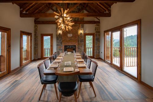 a large dining room with a long table and chairs at Foleya Mountain Resort Hotel & Villas in Trabzon