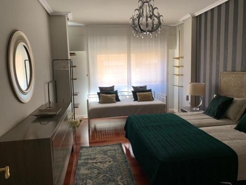 a living room with two beds and a couch at Apartamento Murrieta in Logroño
