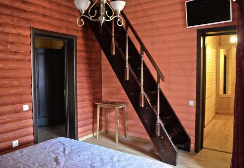 a staircase in a room with a red wall at Knyazhyi Dvir in Myslivka