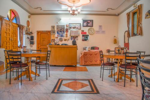 a dining room with wooden tables and chairs at The Wild Trails by Livingstone in Kalpa