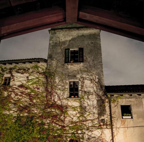 a tall stone tower with windows on a building at Hotel Locanda Dei Mai Intees in Azzate