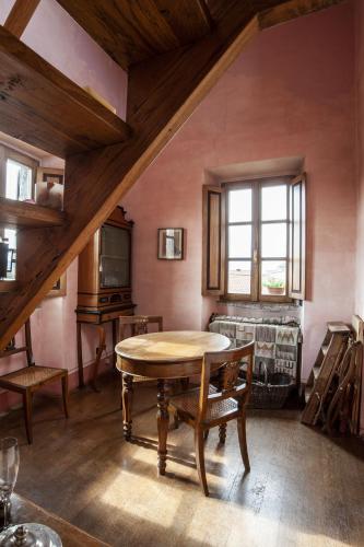 an attic room with a table and a couch at Hotel Locanda Dei Mai Intees in Azzate