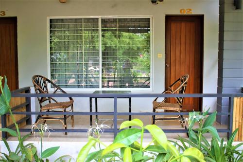 a table and two chairs on a porch at My Parents Guesthouse in Kampot
