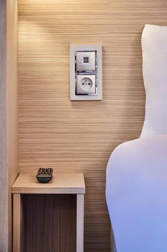 Un ou plusieurs lits dans un hébergement de l'établissement Kyriad ECO - Clermont Ferrand Estaing