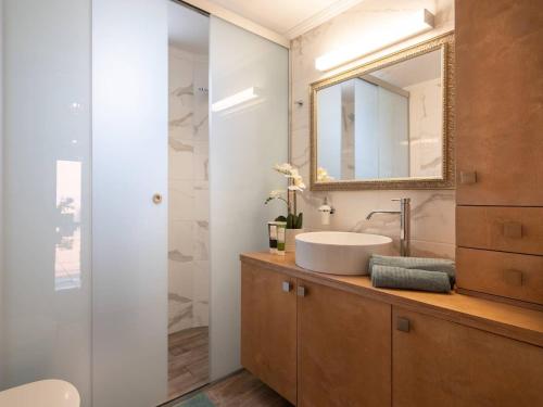 a bathroom with a sink and a mirror at Princess Anna Maria in Hersonissos