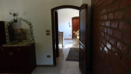 a hallway with a mirror and a brick wall at Homestay Family near Luxor monuments in Luxor