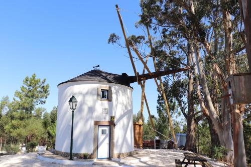 a large white dome house with a black roof at Moinho da Amélia in Cadaval