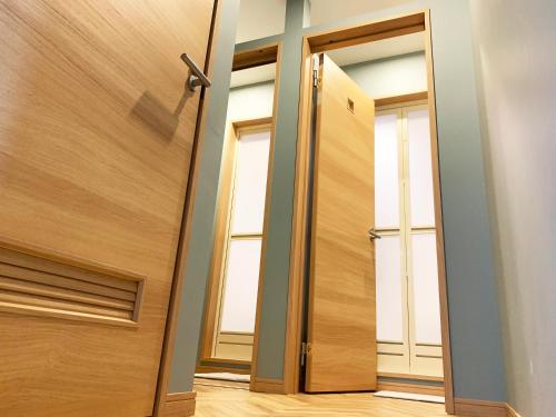 an open door in a room with two windows at Cactus Inn in Miyazaki