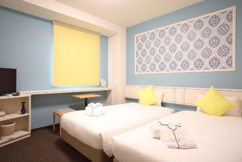 Katil atau katil-katil dalam bilik di HOTEL EURASIA MAIHAMA ANNEX