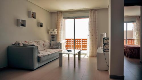 a living room with a couch and a table at Okeanos sea view 1 bedroom VR-S in Granadilla de Abona