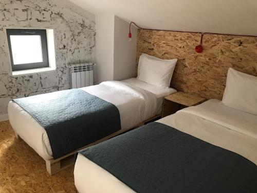 a hotel room with two beds and a window at Vardeni Guesthouse in Hrazdan