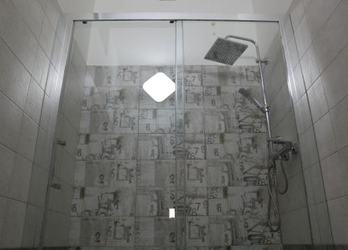 a shower with a glass door in a bathroom at B&B A casa di Emy in Barisciano