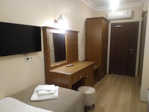 a hotel room with a bed and a dresser and a mirror at Ribad Hotel in Istanbul