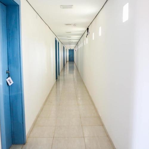 an empty corridor in an office building with a long hallway at Rafa's Pousada Encantos de Minas in Três Corações