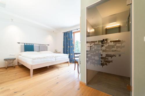 a bedroom with a bed and a wall with a puzzle at Alpinikum Apartments in Lech am Arlberg