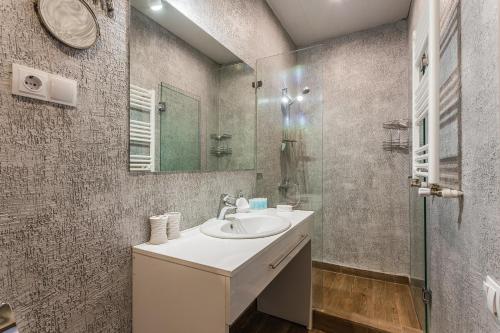 a bathroom with a sink and a glass shower at Good Inn Hotel in Gudauri