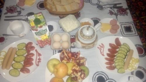 a table with plates of food on a table at Family Guest house - Friends-J in Nukus