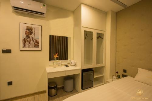 a bedroom with a bed and a sink and a mirror at Golden Hotel in Hanoi