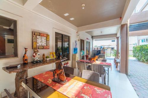 a dining room with a table and chairs and a counter at RedDoorz @ Aparente Gensan in General Santos