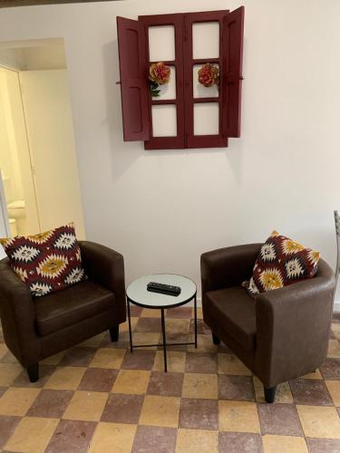 a living room with two chairs and a table at Alter Village Apartments in Alter do Chão