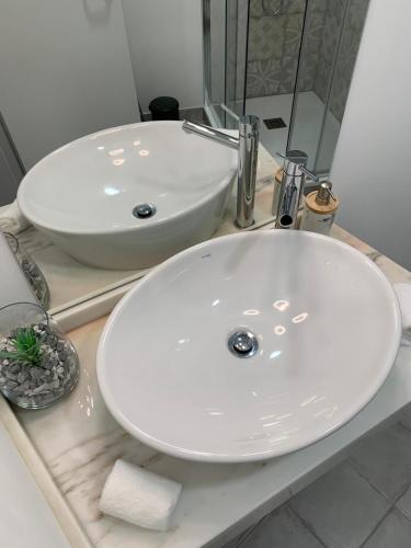 a bathroom with a white sink and a mirror at Alter Village Apartments in Alter do Chão