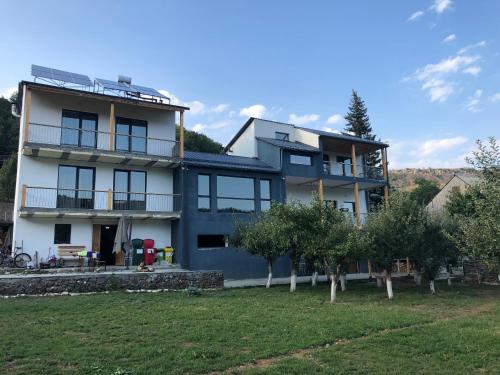 a large house with trees in front of it at Vardeni Guesthouse in Hrazdan