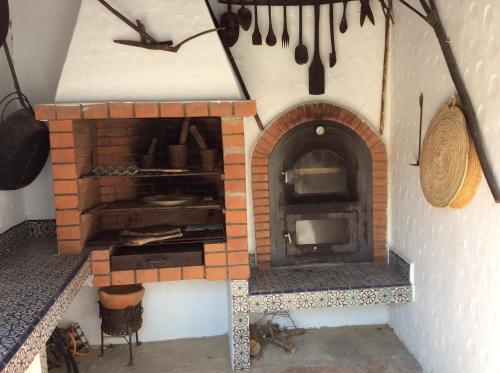a kitchen with a brick oven with pots and pans at La Casa de las Higueras Dar Karmus Tetouan in Tetouan