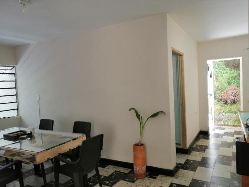 a dining room with a table and chairs at Selvática Alojamiento Eco in Medellín