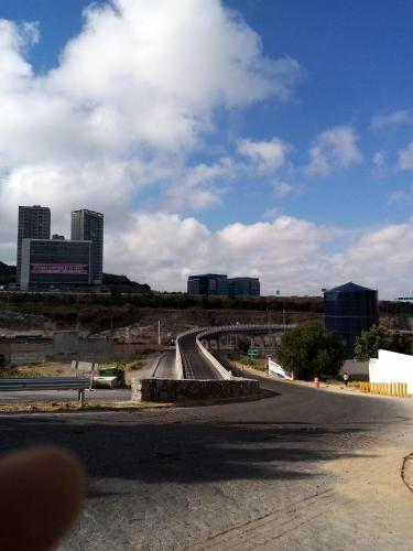 an empty road with a city in the background at Milenio III B&B in Querétaro