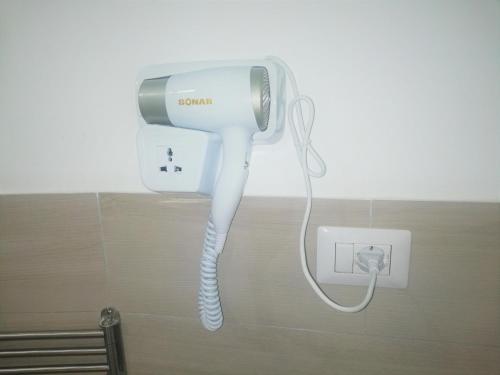 a blow dryer is attached to a wall in a bathroom at AlbaChiara B&B in Gaeta