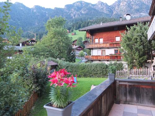 a flower in a pot on the balcony of a house at Apartment Haus Dahoam in Alpbach