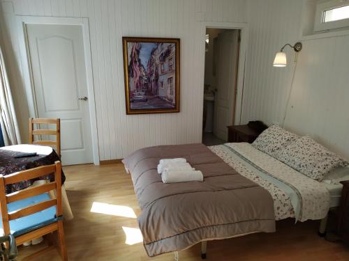 a bedroom with a bed with two towels on it at Pension Alver in Cudillero