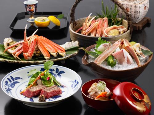 a table topped with bowls of different types of food at Nishimuraya Honkan in Toyooka