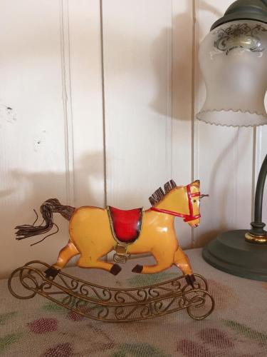a toy horse on a table next to a lamp at Leśny Ogród in Lanckorona