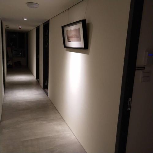 a hallway with a picture hanging on a wall at In Fengchia in Taichung