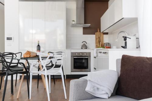 a kitchen and dining room with a table and chairs at The Rambam Residence - By Localz Group in Tel Aviv
