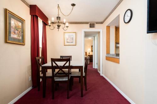 a dining room with a table and chairs and a clock at The Kimball at Temple Square in Salt Lake City
