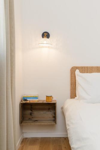 a bedroom with a bed and a nightstand next to a bed at The Rambam Residence - By Localz Group in Tel Aviv