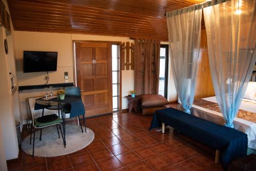 a room with a bed and a table and a couch at COZY LOFT (studio) 360o VIEW OF ATHENS in Athens