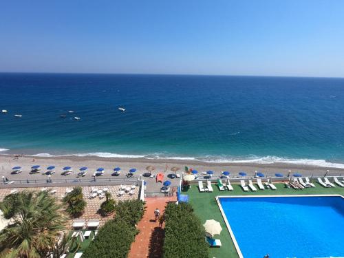 an aerial view of a beach with chairs and a swimming pool at Park Hotel Silemi in Letojanni