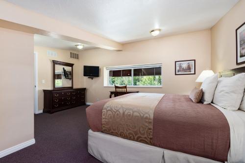 a bedroom with a large bed and a window at The Kimball at Temple Square in Salt Lake City