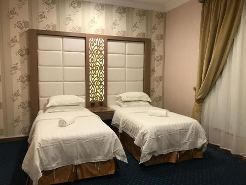 Ένα ή περισσότερα κρεβάτια σε δωμάτιο στο Ajwaa Suites