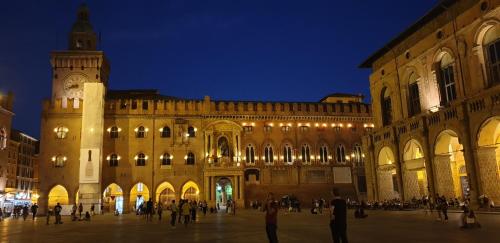 a large building with a clock tower at night at Mars41 B&B in Bologna